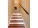 Wooden staircase with white risers, complemented by a dark wood handrail, and a 'Welcome' sign at 1522 3Rd Street E Cir, Palmetto, FL 34221