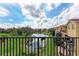 Balcony view of a tranquil pond surrounded by lush landscaping and nearby apartment buildings at 1522 3Rd Street E Cir, Palmetto, FL 34221
