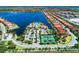 Overhead view of the community clubhouse, tennis court, and stunning lake at 167 Maraviya Blvd, Nokomis, FL 34275