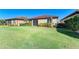 Exterior view of backyard, screened-in patio, and manicured lawn at 167 Maraviya Blvd, Nokomis, FL 34275