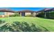 A spacious backyard featuring a well-maintained lawn and lush landscaping at 167 Maraviya Blvd, Nokomis, FL 34275