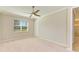 Neutral bedroom features plush carpeting, ceiling fan, crown molding, and natural light at 167 Maraviya Blvd, Nokomis, FL 34275