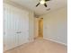 Bright bedroom featuring double door closet and carpet flooring at 167 Maraviya Blvd, Nokomis, FL 34275