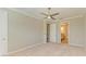 Neutral bedroom features plush carpeting, ceiling fan, crown molding, and ensuite bathroom at 167 Maraviya Blvd, Nokomis, FL 34275
