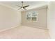 Neutral bedroom features plush carpeting, ceiling fan, crown molding, and natural light at 167 Maraviya Blvd, Nokomis, FL 34275