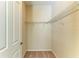 Empty walk-in closet showing the shelving and carpet at 167 Maraviya Blvd, Nokomis, FL 34275