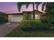 Charming home features a well-manicured lawn, stone accents, and a two-car garage in a tranquil neighborhood at 167 Maraviya Blvd, Nokomis, FL 34275