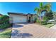 Beautiful home with brick driveway, lush landscaping, and a two-car garage, offering great curb appeal at 167 Maraviya Blvd, Nokomis, FL 34275