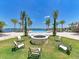 Inviting outdoor firepit surrounded by seating and palm trees, perfect for relaxation at 167 Maraviya Blvd, Nokomis, FL 34275