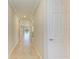 Hallway boasts tile flooring and neutral paint, leading to various rooms in the home at 167 Maraviya Blvd, Nokomis, FL 34275