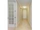 Bright hallway featuring tile floors, neutral walls, and a doorway with a glass paneled door at 167 Maraviya Blvd, Nokomis, FL 34275