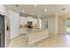 Bright kitchen features stainless steel appliances, gray backsplash, and granite countertops at 167 Maraviya Blvd, Nokomis, FL 34275
