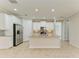 Bright kitchen features stainless steel appliances, gray backsplash, and granite countertops at 167 Maraviya Blvd, Nokomis, FL 34275
