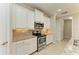 Bright kitchen features stainless steel appliances, gray backsplash, and granite countertops at 167 Maraviya Blvd, Nokomis, FL 34275