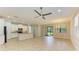 Open living area with a kitchen featuring white cabinets, granite countertops, and stainless steel appliances at 167 Maraviya Blvd, Nokomis, FL 34275