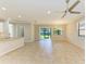 Open-concept space boasts tile flooring, ceiling fan, and sliding door access to the backyard at 167 Maraviya Blvd, Nokomis, FL 34275