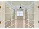 Home office with glass doors, carpet flooring, ceiling fan, and natural light at 167 Maraviya Blvd, Nokomis, FL 34275