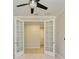 Bright home office with french doors and a ceiling fan at 167 Maraviya Blvd, Nokomis, FL 34275