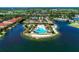 Overhead view of a beautiful community pool and clubhouse surrounded by lush landscaping at 167 Maraviya Blvd, Nokomis, FL 34275