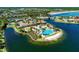 Overhead view of a beautiful community pool and clubhouse surrounded by lush landscaping at 167 Maraviya Blvd, Nokomis, FL 34275