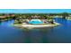 A picturesque community pool and clubhouse are surrounded by waterfront views and blue skies at 167 Maraviya Blvd, Nokomis, FL 34275