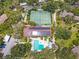 Top-down view featuring tennis courts, pool, and solar panels, showcasing community amenities at 1680 Brookhouse Cir # 110, Sarasota, FL 34231