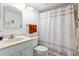 Cozy bathroom featuring a vanity sink, toilet, and shower with a seashell patterned curtain at 1680 Brookhouse Cir # 110, Sarasota, FL 34231