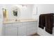Bathroom features a large vanity with ample counter space and a large oval mirror at 1680 Brookhouse Cir # 110, Sarasota, FL 34231