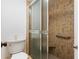 Bathroom features a glass-enclosed shower with tiled walls and a built-in seat at 1680 Brookhouse Cir # 110, Sarasota, FL 34231