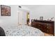 Bedroom with a large wooden dresser, comfortable bed, and bright natural light at 1680 Brookhouse Cir # 110, Sarasota, FL 34231