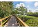 Picturesque boardwalk winding through lush greenery, perfect for serene strolls along the water's edge at 1680 Brookhouse Cir # 110, Sarasota, FL 34231