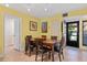 Bright dining area featuring earth-toned flooring and views of the front entrance at 1680 Brookhouse Cir # 110, Sarasota, FL 34231