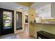 Bright foyer offering views of the dining area and kitchen with breakfast bar at 1680 Brookhouse Cir # 110, Sarasota, FL 34231