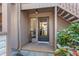 Close-up of the front door entrance with storm door and brick paver landing at 1680 Brookhouse Cir # 110, Sarasota, FL 34231