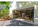 Well-lit garage workshop space with tools and ample storage at 1680 Brookhouse Cir # 110, Sarasota, FL 34231