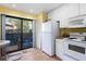 Bright kitchen features patio access and a full appliance package at 1680 Brookhouse Cir # 110, Sarasota, FL 34231