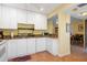 Another view of the charming kitchen with white cabinets and granite countertops at 1680 Brookhouse Cir # 110, Sarasota, FL 34231