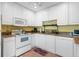 Cozy kitchen with white cabinetry, stainless steel appliances, and granite countertops at 1680 Brookhouse Cir # 110, Sarasota, FL 34231
