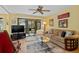 Comfortable living room with a ceiling fan and sliding doors to the patio at 1680 Brookhouse Cir # 110, Sarasota, FL 34231