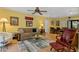 Comfortable living room featuring bright yellow walls, a ceiling fan, stylish furnishings, and views to the dining area at 1680 Brookhouse Cir # 110, Sarasota, FL 34231