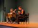 Two women playing guitar on a wood stage at 1680 Brookhouse Cir # 110, Sarasota, FL 34231