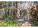 Outdoor patio with seating area surrounded by mature landscaping and lush greenery at 1680 Brookhouse Cir # 110, Sarasota, FL 34231