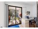 Bright screened porch with comfortable seating, a workstation, and views of backyard at 1680 Brookhouse Cir # 110, Sarasota, FL 34231