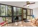 Enclosed porch with multiple windows and nature views perfect for relaxation and leisure at 1680 Brookhouse Cir # 110, Sarasota, FL 34231