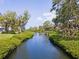 Scenic water view of a tranquil waterway surrounded by lush greenery, creating a peaceful ambiance at 1680 Brookhouse Cir # 110, Sarasota, FL 34231