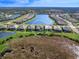 An aerial view of beautiful homes with a tranquil lake and lush landscaping provides a serene backdrop at 17217 Verona Pl, Lakewood Ranch, FL 34202