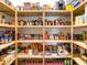 Well-organized pantry with wooden shelves fully stocked with various food items at 17217 Verona Pl, Lakewood Ranch, FL 34202