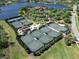 The aerial shot showcases several tennis courts surrounded by manicured landscaping and a beautiful lake view at 17217 Verona Pl, Lakewood Ranch, FL 34202