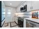 Bright kitchen features stainless steel appliances, granite countertops, and white cabinetry at 1728 Bayonne St, Sarasota, FL 34231