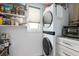 Inside a laundry room with a full size washer and dryer with shelving and storage at 1728 Bayonne St, Sarasota, FL 34231